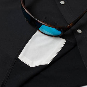 photo of sunglasses with lens cleaner on black shirt