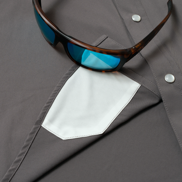 sunglasses with lens cleaner on shirt