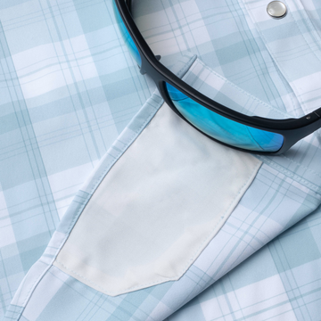 sunglasses with lens cleaner on shirt