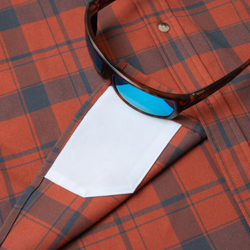 sunglasses with lens cleaner on shirt