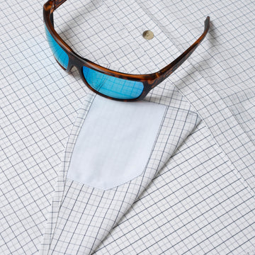 sunglasses with lens cleaner on shirt