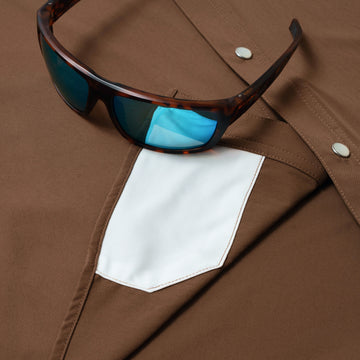 sunglasses with lens cleaner on shirt