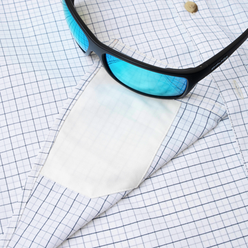 sunglasses with lens cleaner on shirt
