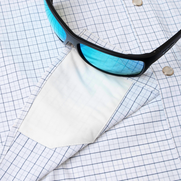 sunglasses with lens cleaner on shirt