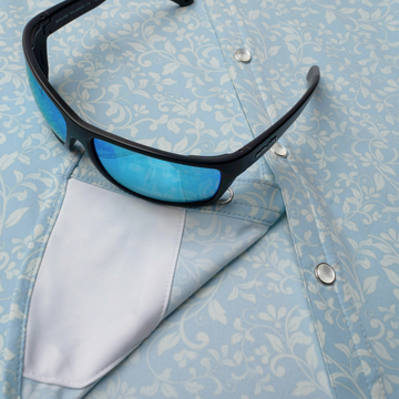 sunglasses with lens cleaner on shirt