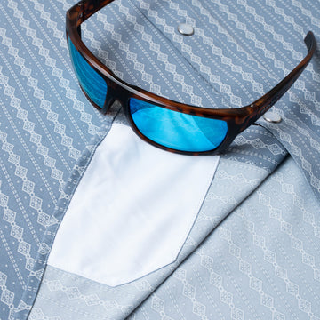 sunglasses with lens cleaner on shirt