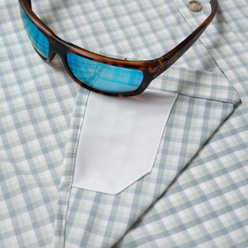 sunglasses with lens cleaner on shirt