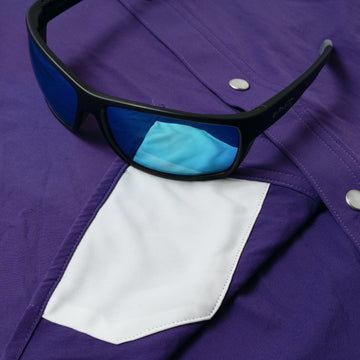 sunglasses with lens cleaner on shirt