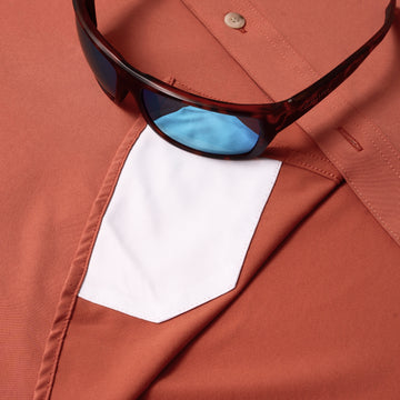 sunglasses with lens cleaner on shirt