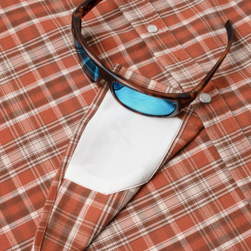sunglasses with lens cleaner on shirt