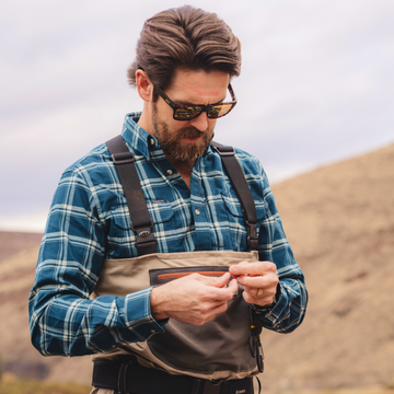 man with sunglasses wearing the deschutes flannel
