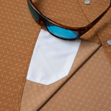 closeup of sunglasses with lens cleaner on shirt