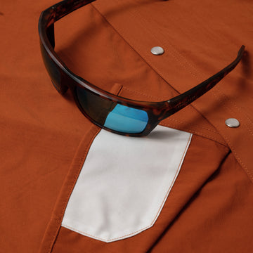 sunglasses with lens cleaner on shirt