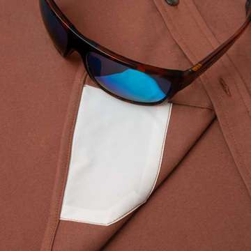 sunglasses with lens cleaner on shirt