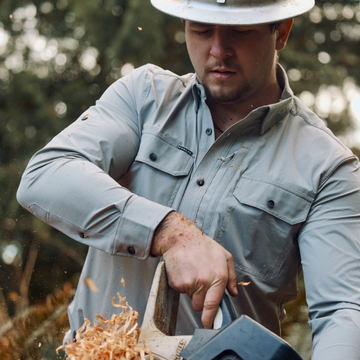 man using chainsaw wearing the logger tuff-thread shirt
