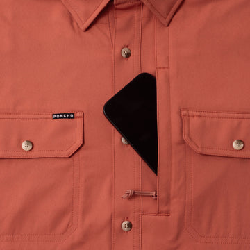 phone in chest zipper pocket of shirt