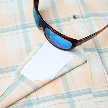 sunglasses with lens cleaner on shirt