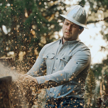man. cutting wood wearing the logger tuff-thread shirt