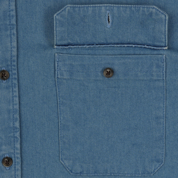 The Franklin blue denim shirt featuring a buttoned chest pocket and durable stitched detailing