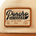 Close-up of a beige and brown fabric patch on a hat with the words "Poncho Outdoors Wild Places Get Out There USA 2018" embroidered.