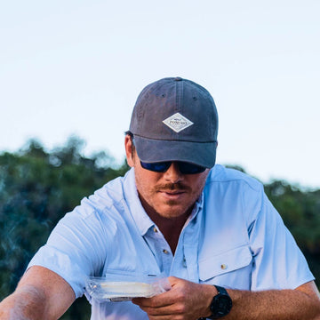Man Wearing grey diamond patch hat