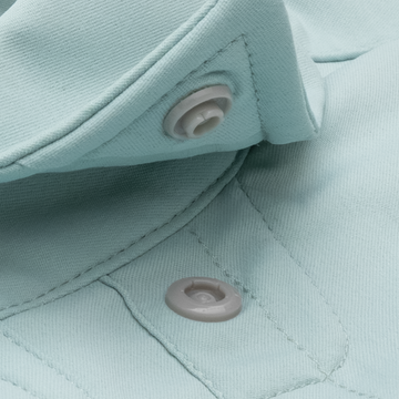 close up photo of button snap collar on light blue fishing shirt