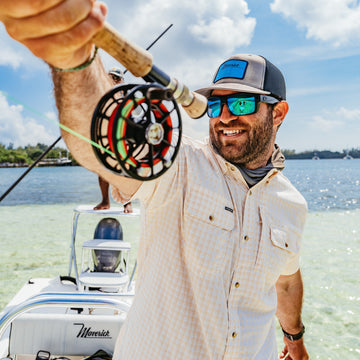 man smiling holding fishing rod