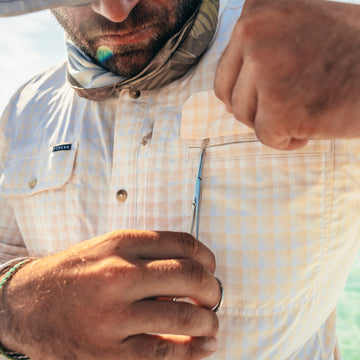 man holding scissors next to chest pocket