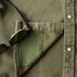 Detail shot of lens cleaning cloth on green denim shirt