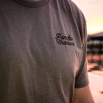 man wearing grey revolver t-shirt