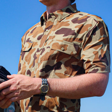 man wearing short sleeve camo shirt