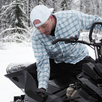 Man in flannel on a snowmobile