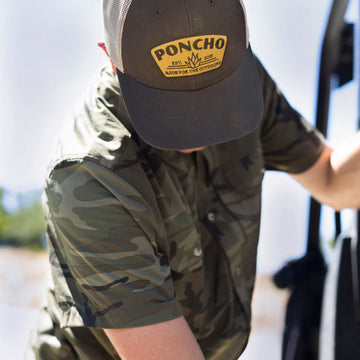 man wearing short sleeve camo shirt