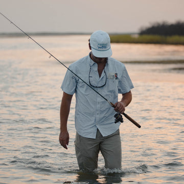 man wading with fishing rod