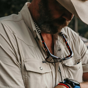 man wearing tan short sleeve western
