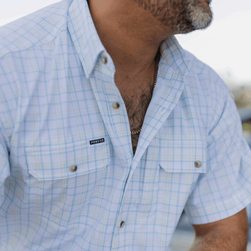 Close up of many wearing blue and yellow button down shirt