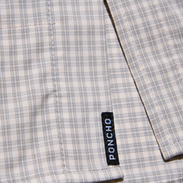 poncho logo on grey and white plaid shirt tail