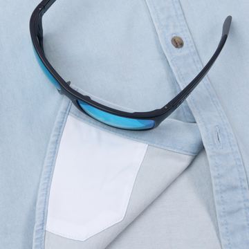 The Judd sunglasses resting on a light blue shirt with a white chest pocket