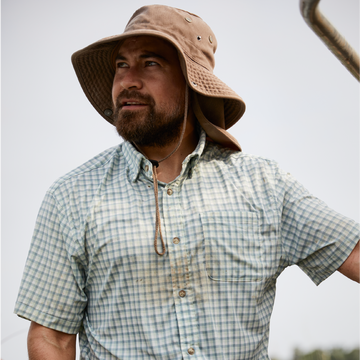 man wearing green grid short sleeve button up shirt