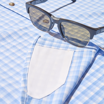 closeup of shades and lens cleaner on shirt
