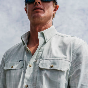 Man fishing in green plaid button down fishing shirt