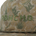 Close-up of a beige cap with green cactus patterns and "PONCHO" embroidered in green letters on the front panel.