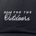 Close-up of black fabric hat with white embroidered text reading "MADE FOR THE Outdoors" on the front panel.