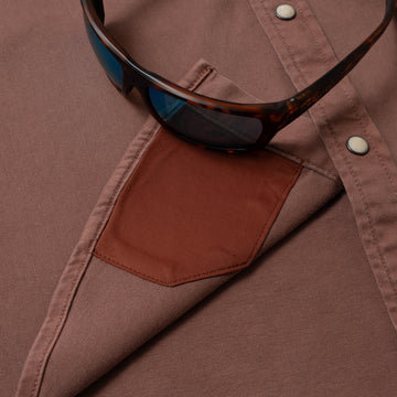 sunglasses with lens cleaner on shirt