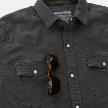 Detail shot of black denim shirt with sunglasses
