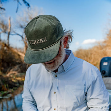 man wearing moss corduroy hat