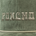 Close-up of olive green corduroy fabric with beige embroidered text "PONCHO" and a beige cord trim below.