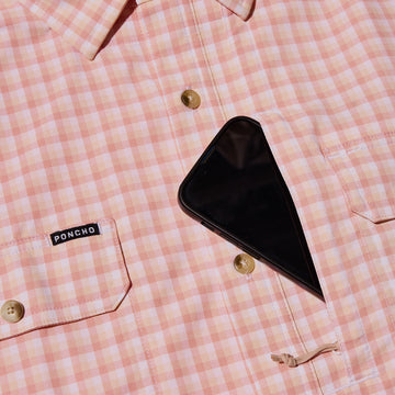 closeup of phone going into chest pocket