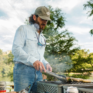 Man cooking wearing olive diamond patch hat