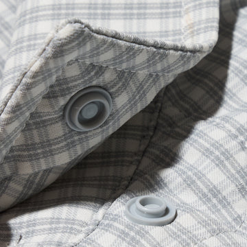 close up of snap buttons on micro grid grey button up shirt